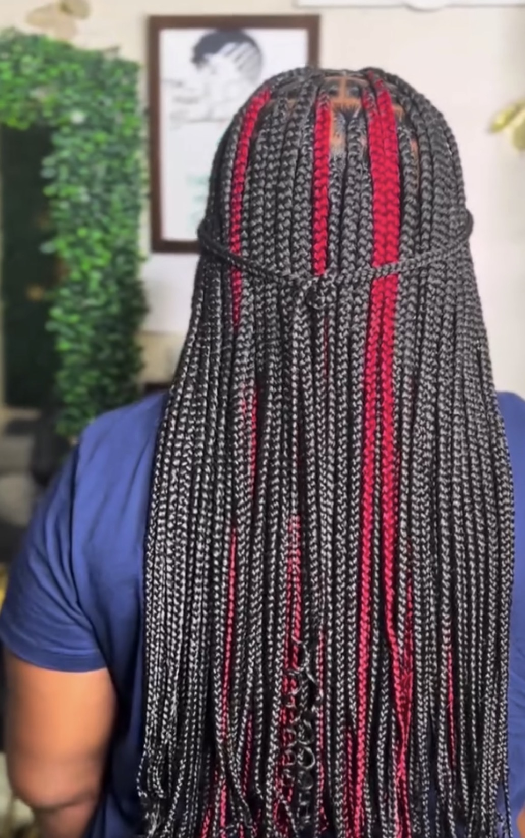 Box braids with red accents